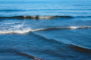 Fantastic soft wave layers on sand at the sea.