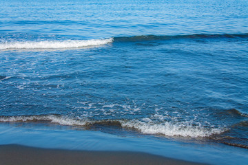 Fantastic soft wave layers on sand at the sea.