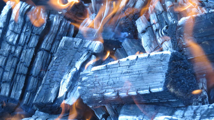 Macro photo of burning coals in the fireplace with fire