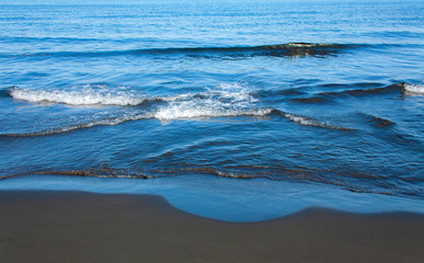 Fantastic soft wave layers on sand at the sea.