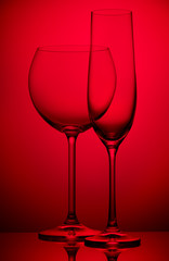 Two wineglasses on red