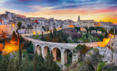 Gravina in Puglia ancient town, bridge and canyon at sunrise. Panoramic view of old city Gravina in Puglia, Apulia, Italy. Europe
