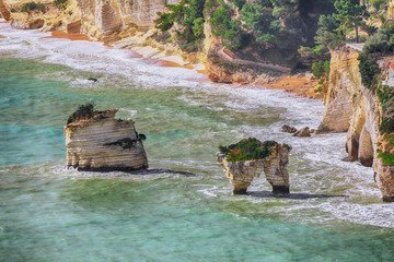 Picturesque islets Faraglioni di Puglia in summer Adriatic sea bay Baia Delle Zagare