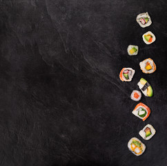 Japanese sushi set on black stone background
