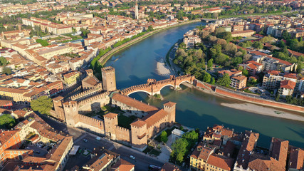 Fototapeta premium Aerial drone photo from iconic fortified medieval castle and bridge of Castelvecchio used as a museum, Verona, Italy