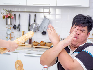 Asian fat man reject unhealthy food from another people