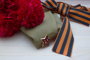 Victory day composition with clove, flight cap and saint George ribbon with free space