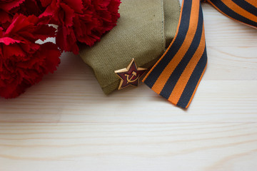 Victory day composition with clove, flight cap and saint George ribbon with free space