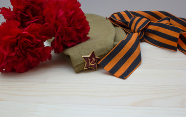 Victory day composition with clove, flight cap and saint George ribbon with free space