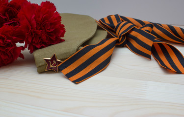 Victory day composition with clove, flight cap and saint George ribbon with free space
