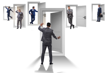 Fototapeta premium Businessman in uncertainty concept with many doors