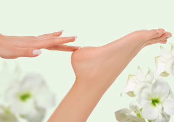 woman touching her smooth foot. smooth and beautiful female foot, spa and heel care