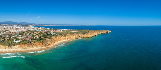 Aerial Scenic seascape, of Ponta da Piedade promontory (cliff formations along coastline of Lagos city), natural landmark destination, Algarve. South Portugal.