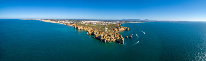 Aerial Scenic seascape, of Ponta da Piedade promontory (cliff formations along coastline of Lagos city), natural landmark destination, Algarve. South Portugal.