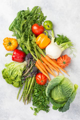 Fresh raw vegetables on off white background, top view, selective focus