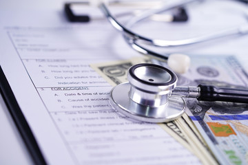 Health insurance accident claim form with coin money and car. 