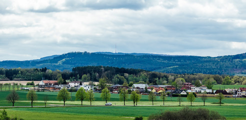 Fototapeta na wymiar Outdoor car ride on spring czech landscape with hill Klet