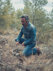 attractive man with beard posing in the field