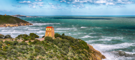 Summer rocky sea coast near Architello (Arch) of San Felice on the Gargano peninsula