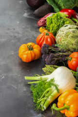 Fresh raw vegetables, cabbage carrots broccoli asparagus pepper fennel tomatoes salad on dark background, copy space, selective focus
