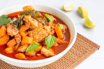 Thai Red Chicken Curry in a Bowl Served with Rice and Lemon Photo. Flavorful Thai Red Curry with Basil Leaves, Thai Cuisine, Oriental Cuisine Photography.