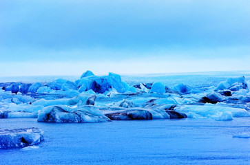 View of Jokulsarlon Glacier Lagoon at the Vatnajokull National Park in Iceland on a foggy morning in winter.