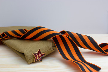Victoru day composition with soviet flight cap and Saint George ribbon