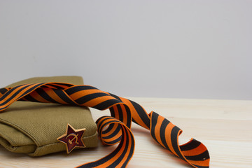 Victoru day composition with soviet flight cap and Saint George ribbon