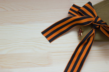 Victoru day composition with soviet flight cap and Saint George ribbon