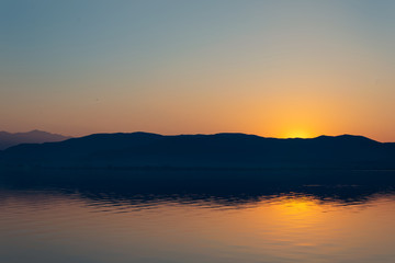 View of the lake and mountains on a sunny spring day.