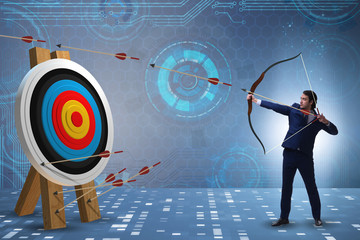 Businessman aiming arrow with bow