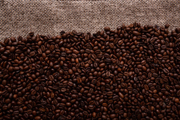 Coffee beans and sackcloth background., place for text