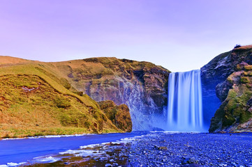 View of Skogafoss waterfall at dawn in winter in Iceland.