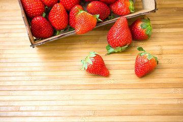 Fresh juicy strawberries on a bamboo mat. Close-up view photography.