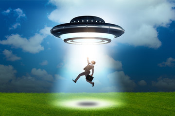 Flying saucer abducting young businessman 