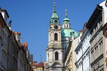 Fototapeta na wymiar Mostecka Street with St. Nicholas Church