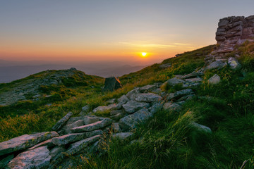 Fototapeta premium Warm summer season in the Ukrainian Carpathians with view of the observatory White elephant and tourist with a tent against the background of the mountains