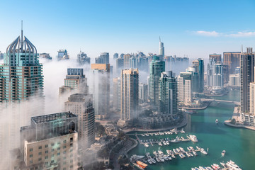 Dubai skyline, an impressive aerial top view of the city in Dubai Marina on a foggy day 