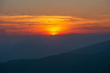 Warm summer season in the Ukrainian Carpathians with view of the observatory White elephant and tourist with a tent against the background of the mountains