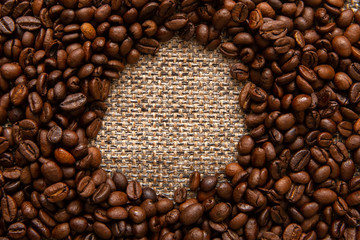 Coffee beans and sackcloth background, place for your brand