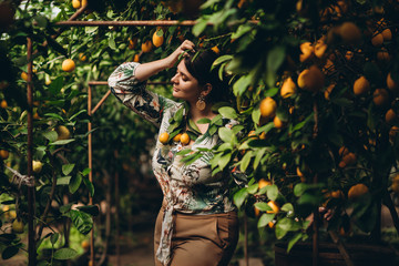 Woman among plants in lemon gardens