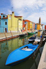 Boats anchored in canal in Burano, Venice, Italy