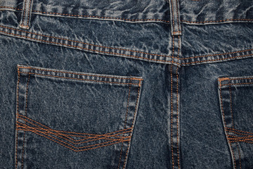 back of jeans. classic blue jeans back pockets. Classic jeans with five pockets close-up. Rough blue textured denim. trendy casual style