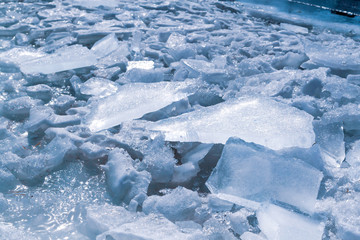 A pile of broken ice lit by the spring sun.