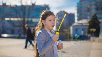 girl, white t-shirt and gray jacket, city, soap bubbles, sad