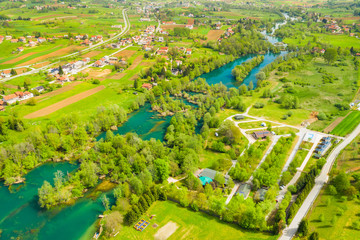 Croatian countryside landscape, beautiful green Mreznica river from air, panoramic view of Belavici village and waterfalls in spring, popular tourist destination
