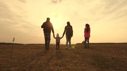 Dad, Mom, small child and daughters and pets tourists. teamwork of a close-knit family. family travels with the dog on the plain. The concept of a sports family holiday in nature.