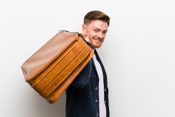 Redhead man holding a vintage briefcase