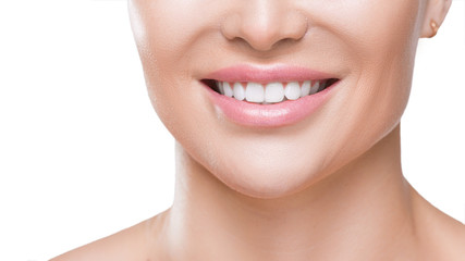 Closeup view of a woman's smile with white healthy teeth, isolated on white