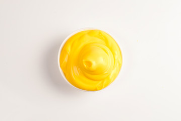Cheese sauce in white plate on white background.